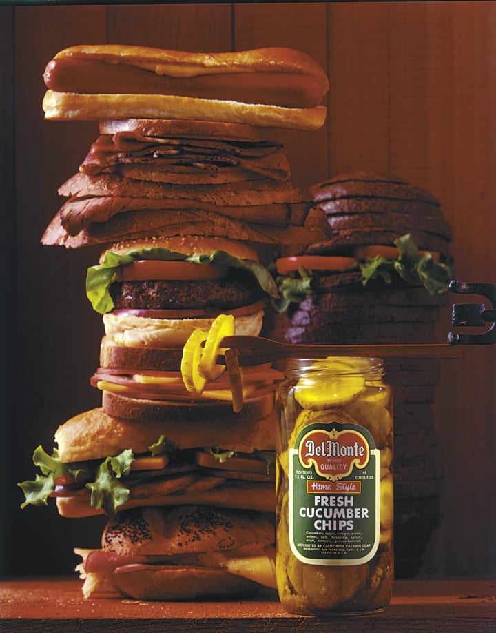 Del Monte Fresh Cucumber Chips next to a tall stack of sandwiches, undated. From the Milton "Hal" Halberstadt Papers