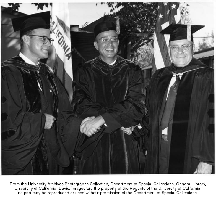 President Clark Kerr of the University of California grips the hands of Chancellor Emil M. Mrak, right, and Vice-Chancellor Everett Carter at the conclusion of inaugural ceremonies in the Sunken Garden of the Davis campus, 1959 October 23.