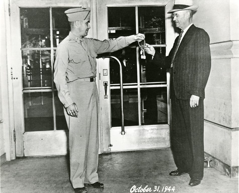  At the end of the WSCS activities, the Army returned the keys of the campus to Controller Ira Smith (right), chief acting university officer, 1944 October 31 