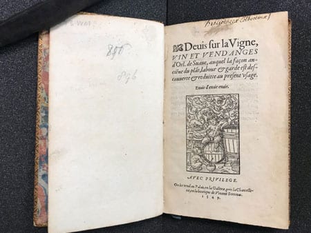 1549 book " Deuis sur la vigne, vin et vendages" opened to cover page.