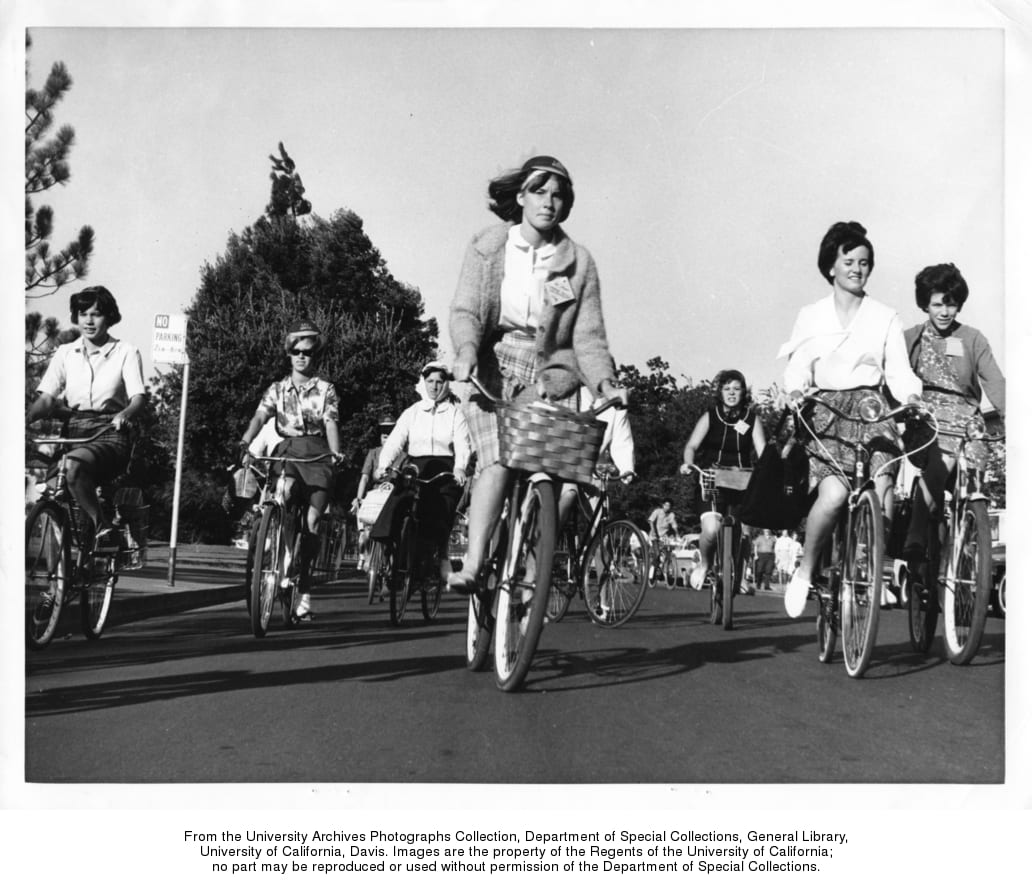 Women riding bicycles on campus, circa 1967