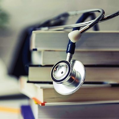 stethoscope on top of textbooks