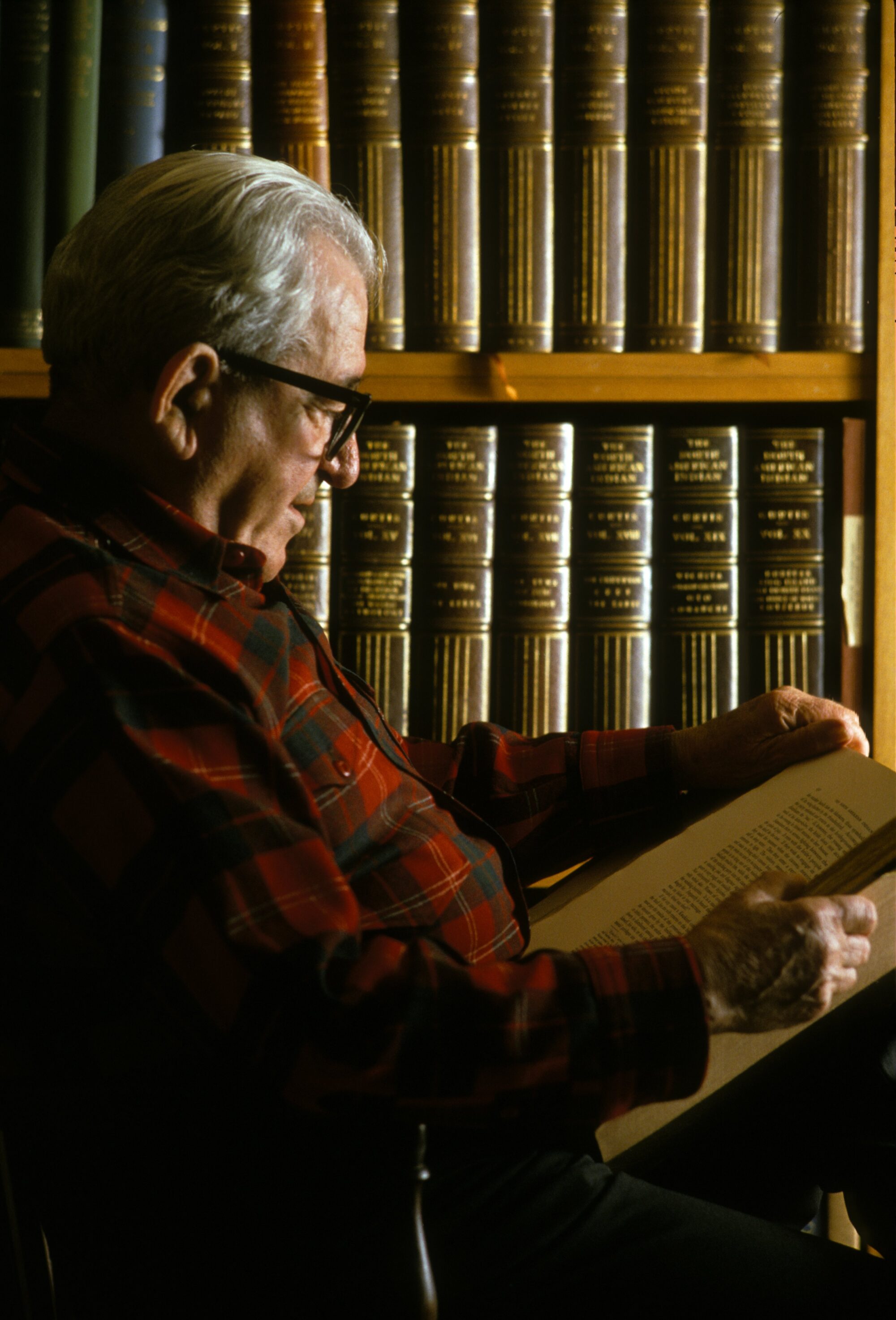 Michael Harrison reading a volume from Edward S. Curtis' The North American Indian.