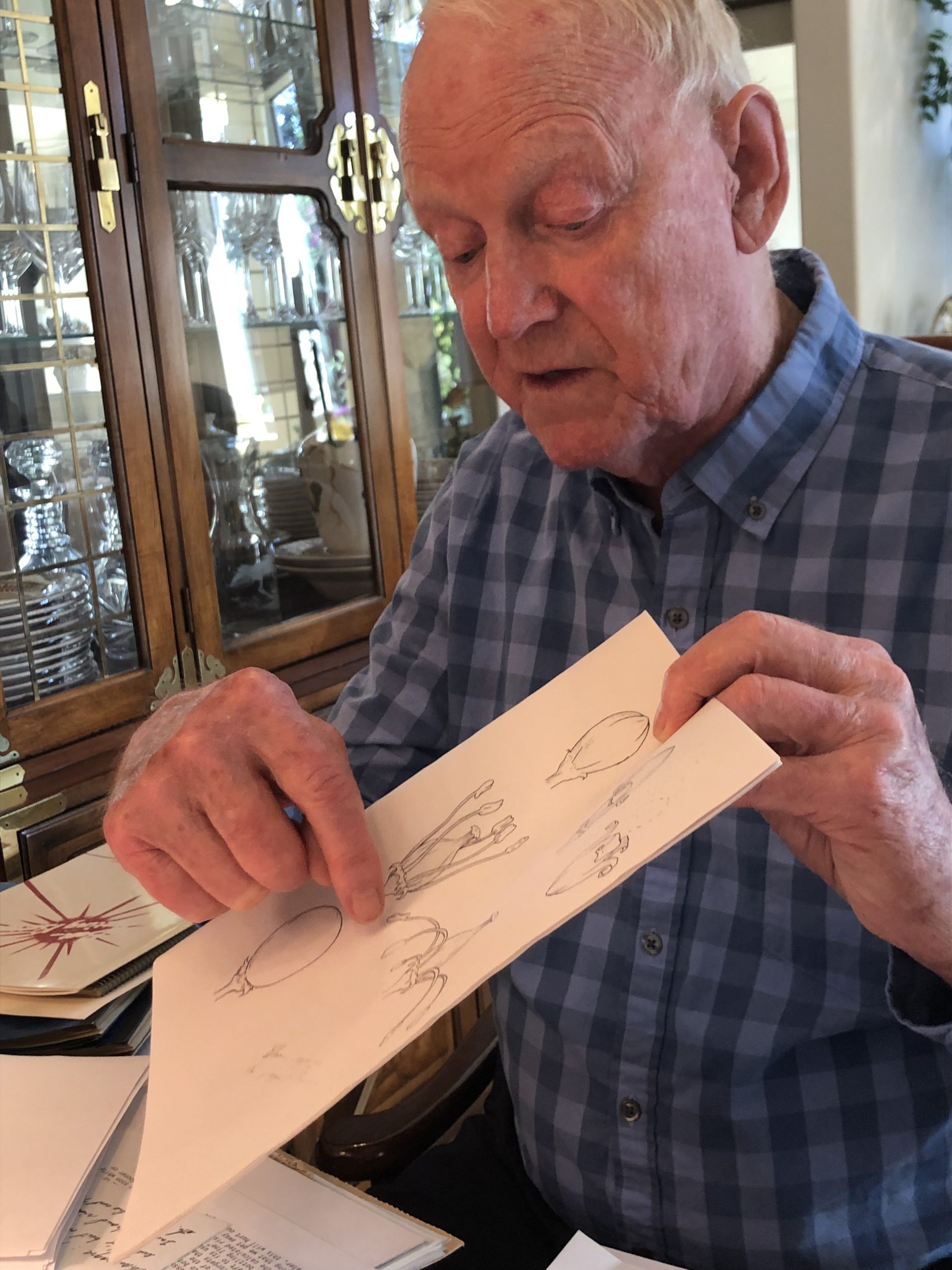 Dick Peterson at his home showing a diagram he created of the flower for an individual grape berry in a cluster on a grapevine.