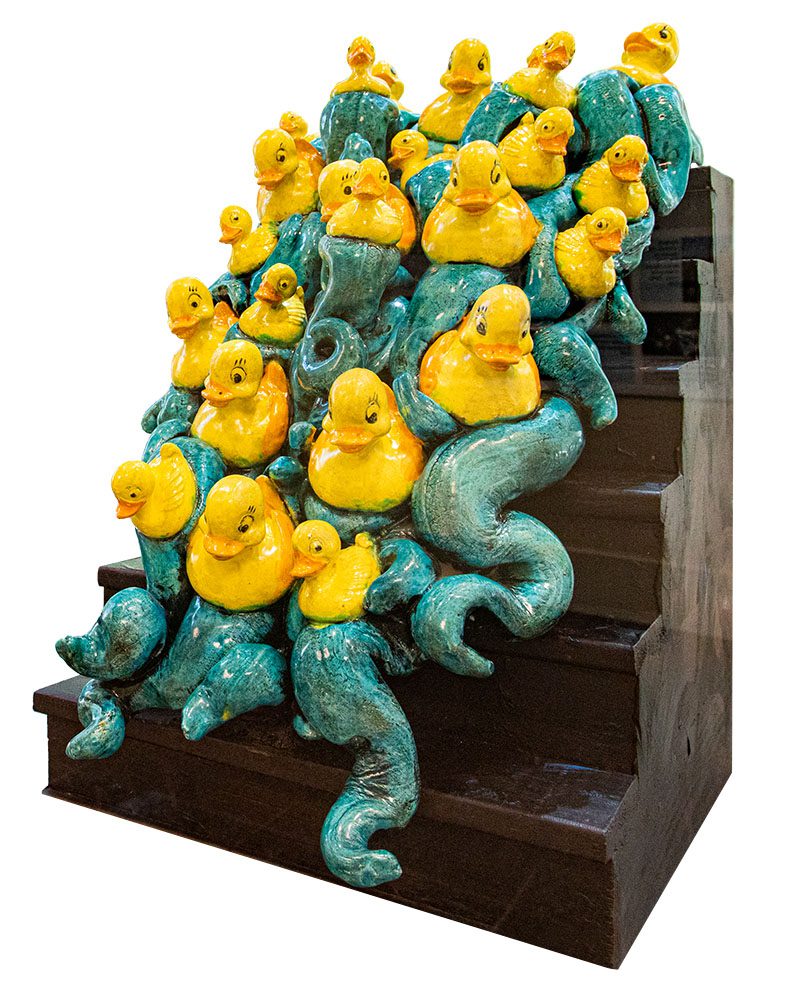 ceramic rubber ducks on waves descending a wooden staircase