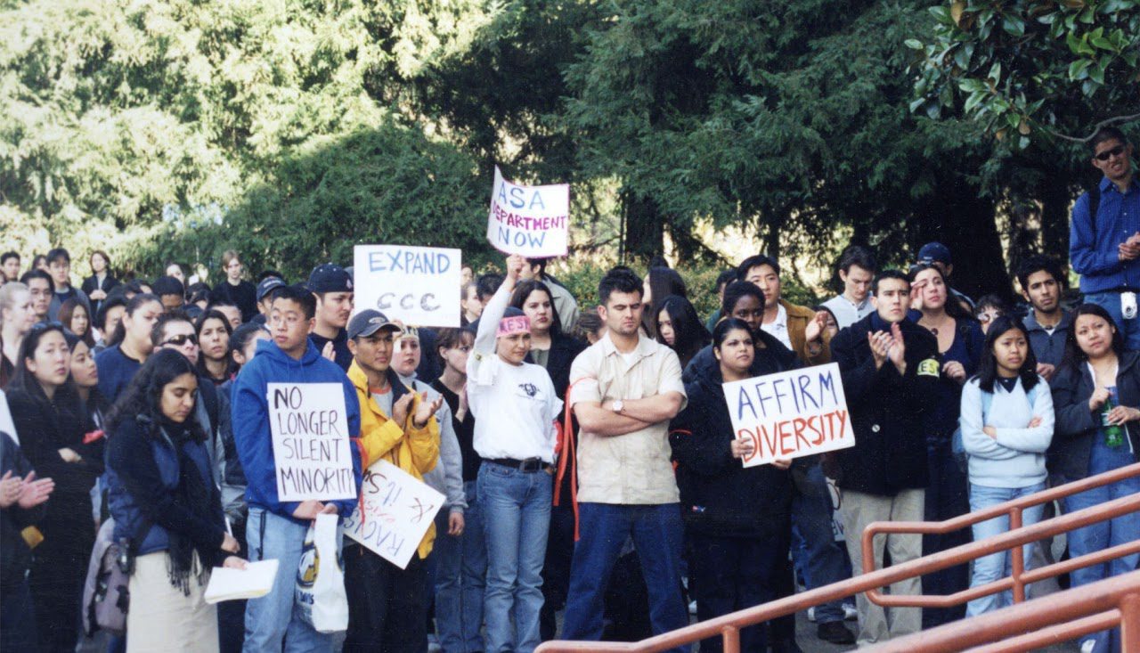 UC Davis students holding signs and protesting University Administration.