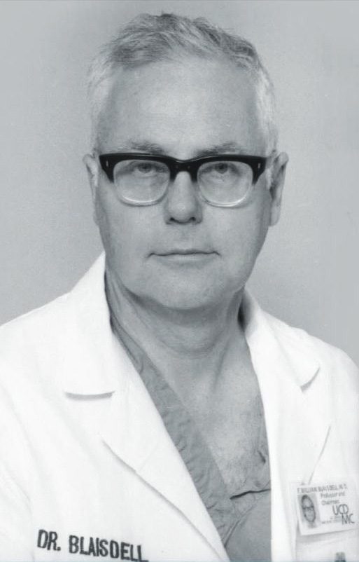 Black and white portrait of Dr. Blaisdell in a lab coat