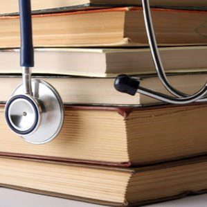 Closeup of textbooks with stethoscope on top