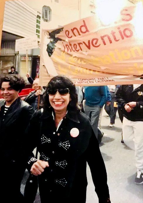 Betita Martinez marching in a street protest in the 1980s