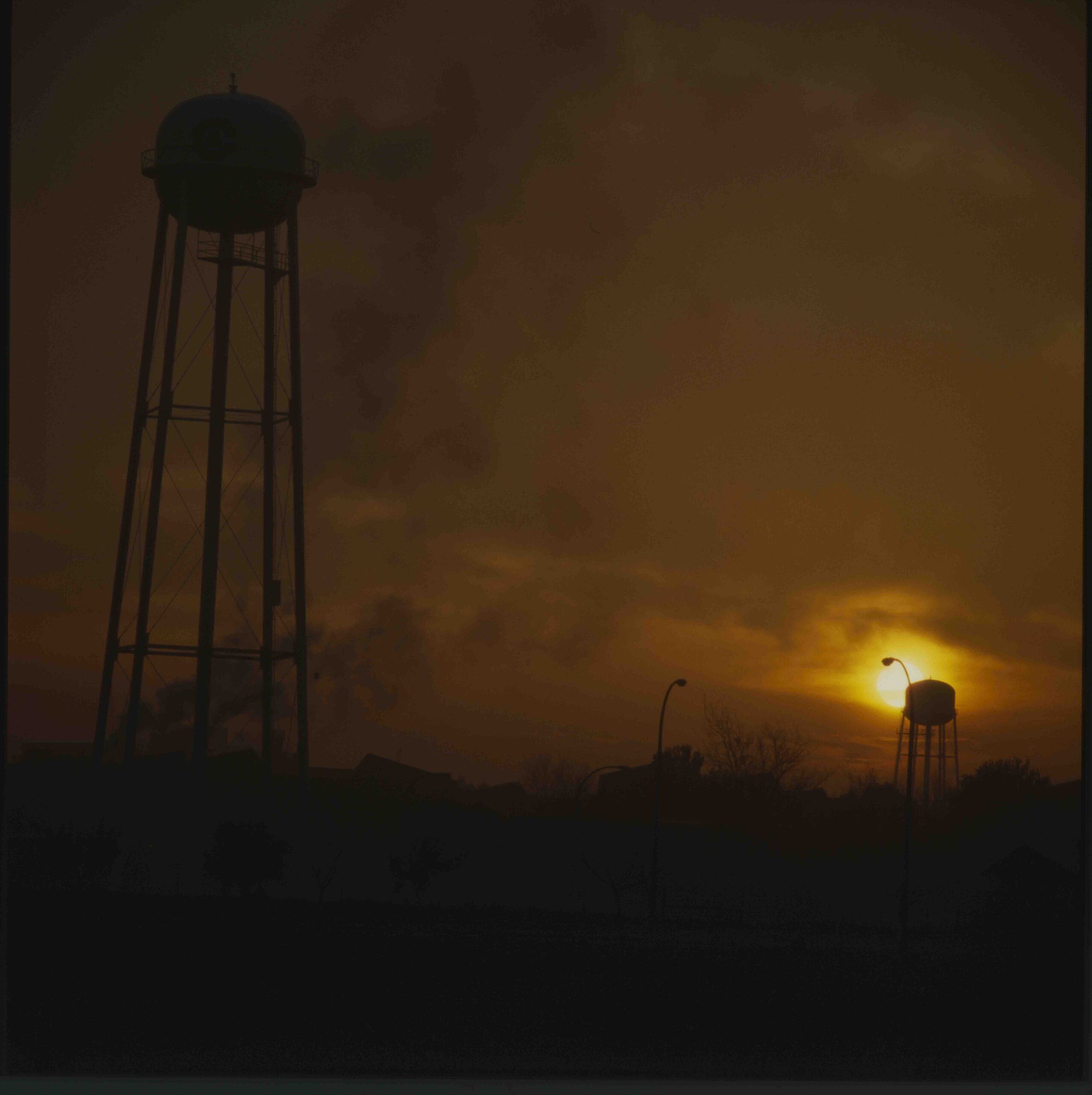 Two water towers at sunset