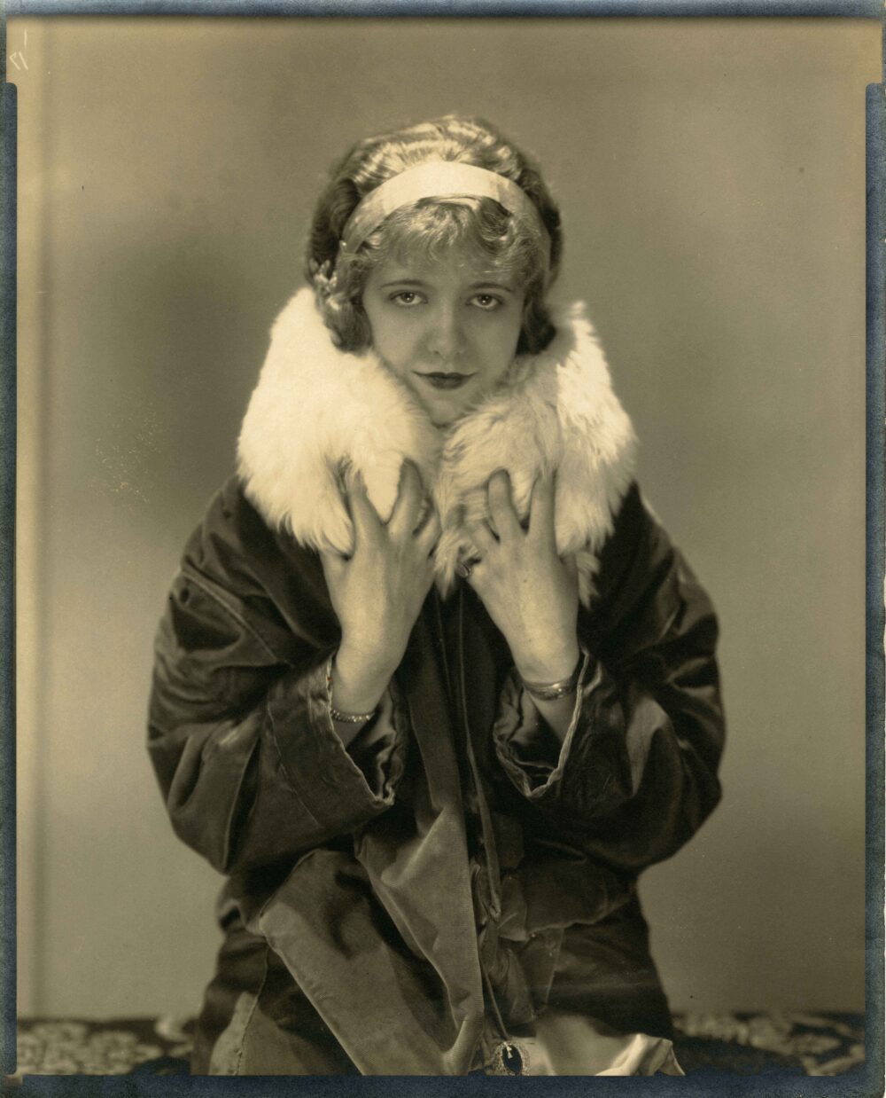 Portrait of a woman wearing a coat with fur neckline