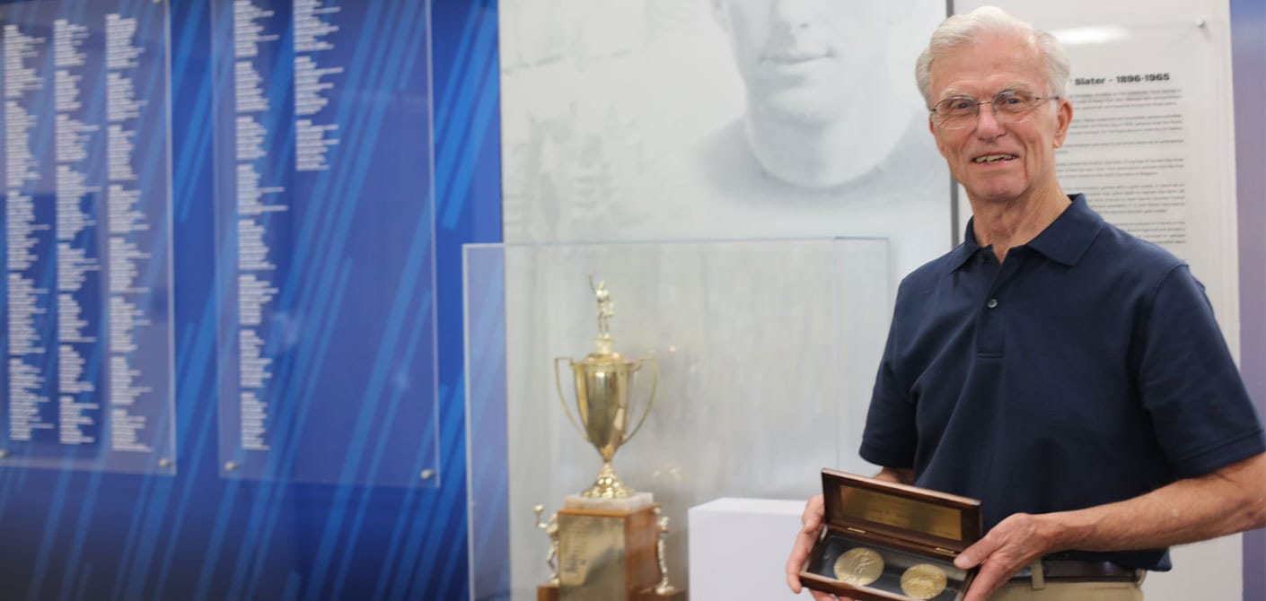 Dick McCapes, Babe Slater’s son-in-law, holds Slater’s Olympic gold medals from 1920 and 1924 at UC Davis’ Colby E. “Babe” Slater Athletic Hall of Fame