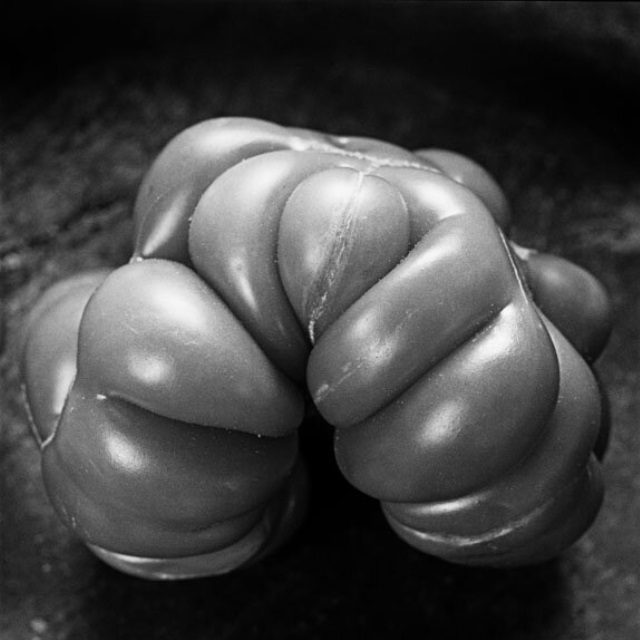 Black-and-white photograph of an heirloom tomato, resembling a fist