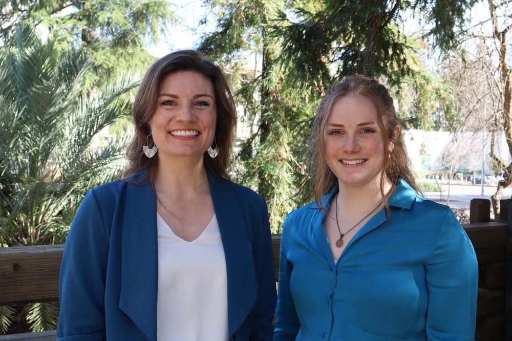 Portrait of Mikhaila Redovian and Kirsten Schuhmacher with trees and greenery in the background