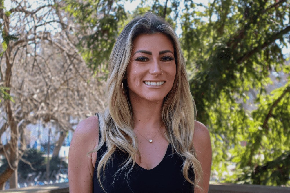 Portrait of 2026 Grad Prize Winner Andrea Guggenbickler with trees in background