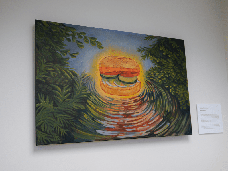 Acrylic on canvas of "everything" bagel sandwich framed in greenery