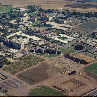 Aerial view of UC Davis. There are many buildings in the photo and a construction area in the foreground.